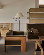 Minimal floor lamp paired with modern wooden furniture