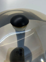 Top view of glass dome shade with central metal detail