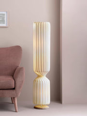 Twisted column floor lamp beside upholstered chair