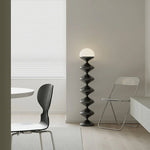 Sculptural black floor lamp in contemporary dining space