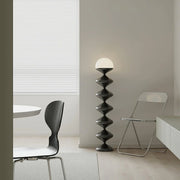 Sculptural black floor lamp in contemporary dining space