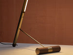 Close-up of brass counterweight base of designer floor lamp