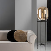 Designer amber glass floor lamp placed beside sofa