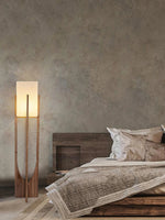 Modern wooden floor lamp illuminating a living room interior
