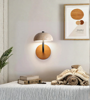 Wall-mounted lamp with a wooden finish in a room setting.