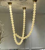 Chandelier with round lights hanging from the ceiling