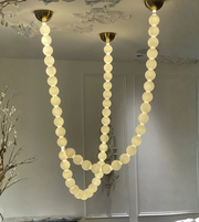 Chandelier with round lights hanging from the ceiling