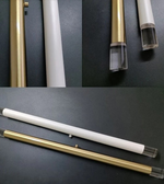 Collage of a white pen with gold accents on a dark surface