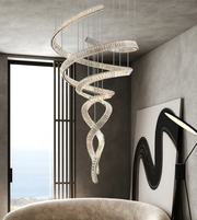 Spiral chandelier hanging in a modern interior setting with a chair and wall art.