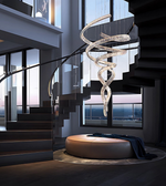 Modern staircase with a decorative chandelier in a high-rise building.