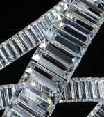 Close-up of a diamond bracelet with clear stones on a black background