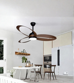 Ceiling fan in a modern kitchen with white walls and wooden shelves.