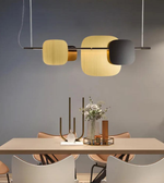 Modern dining room with a stylish pendant light fixture over a table.