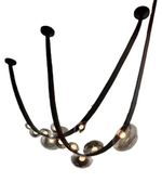Modern chandelier with black curved arms and glass globe shades on a white background