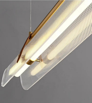 Modern pendant light with gold fixture and clear mesh shade on a gray background