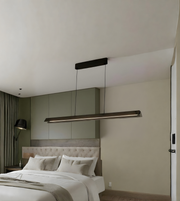 Modern bedroom with a bed and pendant light fixture.