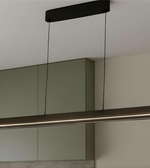 Modern pendant light fixture hanging above a mirror in a bathroom setting.