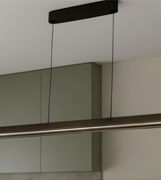 Modern pendant light fixture hanging above a mirror in a bathroom setting.