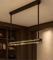 Modern pendant light fixture in a room with wooden shelves and warm lighting.