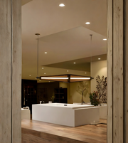 Modern bathroom with a large mirror reflecting the room's interior.