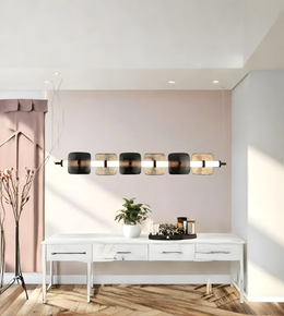 Modern interior design with a long wall-mounted light fixture, white console table, and pink wall.