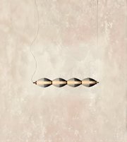 Modern pendant light with geometric design on a neutral background