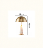 Gold table lamp with measurements on a white background