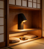 Traditional Japanese interior with a black lamp on a wooden shelf.
