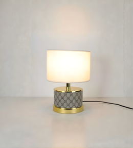 Table lamp with geometric patterned base on a plain background