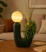 Decorative lamp with spherical light bulb on a wooden table in a cozy living room.