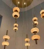 Modern chandelier with multiple hanging lights in a room setting