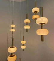 Modern pendant lights with glass shades on a neutral background