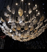 Luxurious chandelier with leaf-shaped crystals on a dark background
