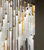 Modern chandelier with glass and metal elements on a dark background