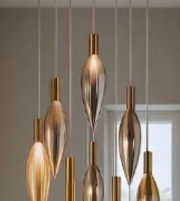 Gold pendant lights hanging from a ceiling