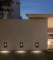 Modern building exterior with wall-mounted lights at night