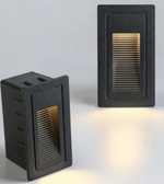 Two rectangular black outdoor lights on a light gray background