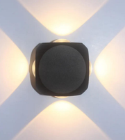 Modern wall light fixture on a white wall with geometric patterns