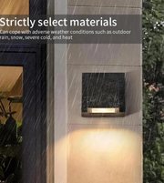 Outdoor wall light fixture on a wooden post with raindrops, text about material selection.