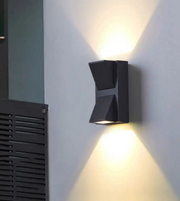 Modern outdoor wall light fixture on a gray wall