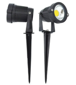 Two black outdoor garden lights with spikes on a white background