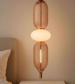 Decorative pendant light with mesh design on a neutral background