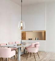 Modern dining area with pink chairs and a white table in a minimalistic kitchen.