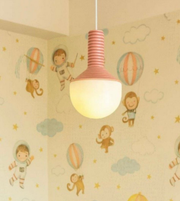 Children's room with a pink pendant light and wallpaper featuring space-themed illustrations.