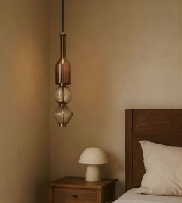Bedroom with wooden headboard, bedside table, and pendant light fixture.