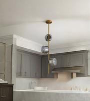 Modern kitchen with gray cabinets, pendant light, and white countertop.