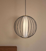 Spherical pendant light with wireframe design on a beige wall