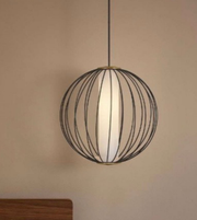 Spherical pendant light with wireframe design on a beige wall