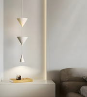 Modern pendant light fixture on a white wall with a minimalistic interior setting.