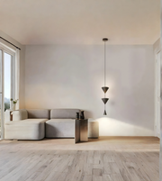 Modern living room with a light gray sofa, wooden floor, and pendant lamp.